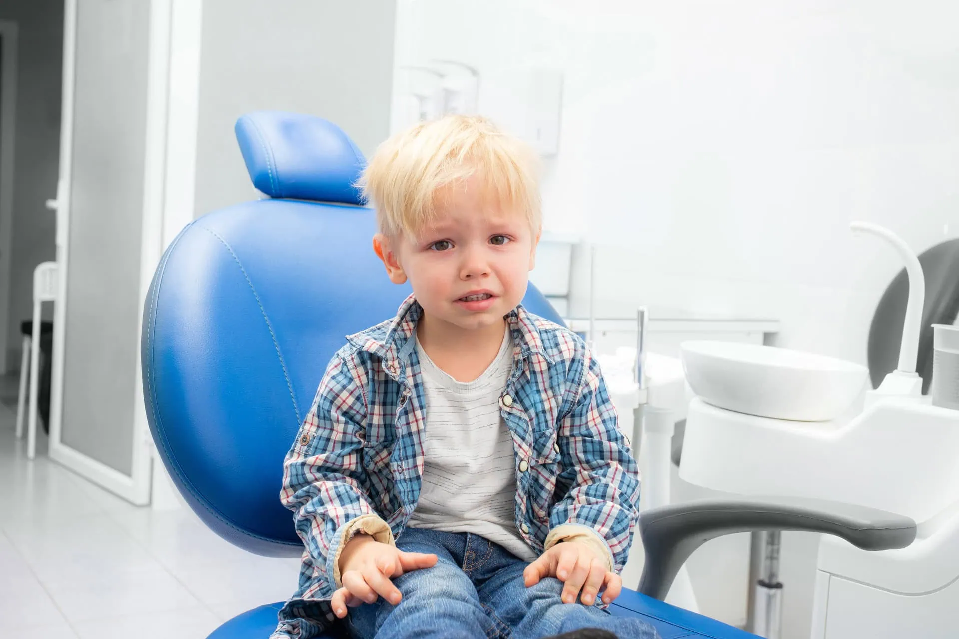 A caring pediatric dental specialist treating a child in an emergency dental situation